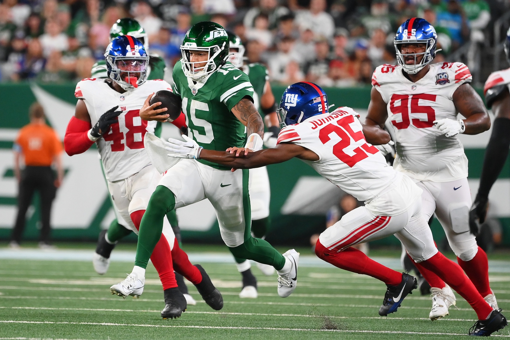 New York Jets quarterback Adrian Martinez (15) runs with the ball past New York Giants cornerback Alex Johnson (25) during the first half at MetLife Stadium. This matchup, highlighted by dynamic plays and intense rivalry, exemplifies why football is among the Best Sports to Bet On. A Statistical Analysis shows that games like these often provide thrilling betting opportunities due to their unpredictable nature and high stakes. Mandatory Credit: Rich Barnes-USA TODAY Sports